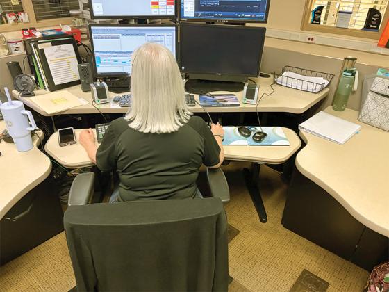 A dispatcher waits for calls at the Gilmer County 911 Communications Center. (Photo by Frank Copeland)