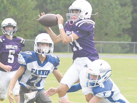 Clear Creek’s Myles Keogh (11) and Kamden Becker (9, below) intercept passes during the Bobcats’ 30-6 victory over Fannin County last Wednesday
