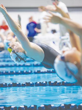 Ellijay’s Payton Woodring dives into the pool for the backstroke during her junior season at the University of Cincinnati. 