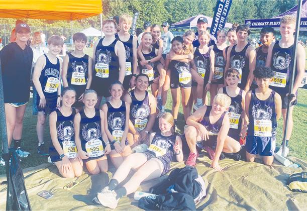 Clear Creek cross-country runners join coaches Adam Palmer and Paige Johnstone following the War Eagle Invitational. (Contributed photo)