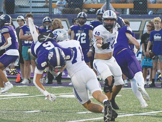 Gilmer senior defensive lineman Jack Puckett (71) takes down a Panther running back for a loss last Friday at Union County as teammate Robert Pim (40) closes in to assist.