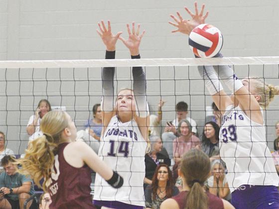 Gilmer volleyball players Roxy McVey (14) and Jace Sanderson (33)