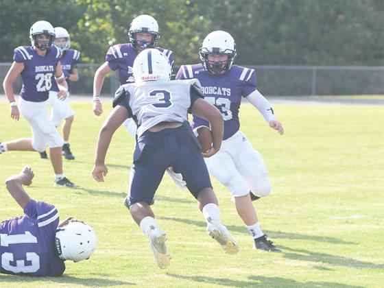Eighth grader Tate DeBoard (53) corrals a running back.