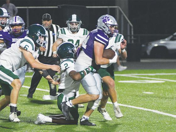 Gilmer High junior fullback Peyton Chancey drags a Westminster defender last Friday and finished with 164 yards rushing and four touchdowns.