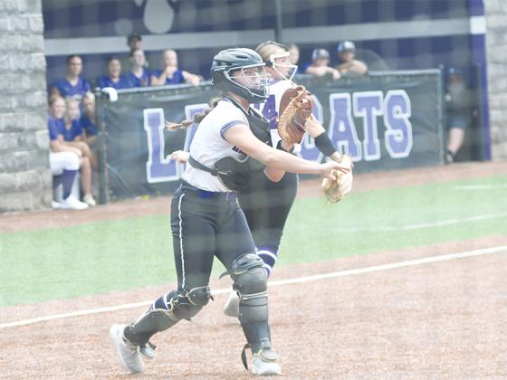 Gilmer High freshman catcher Brenlee Daniel makes a throw to first base.