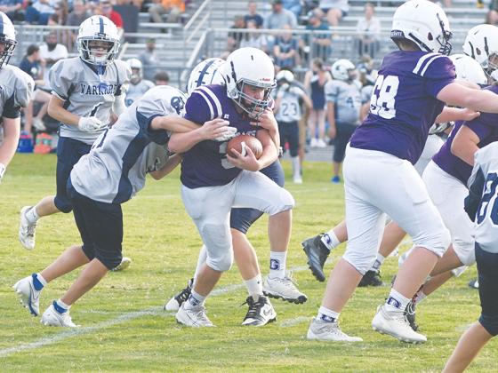 Clear Creek Middle School seventh grade fullback Jaxon Garland breaks a tackle.
