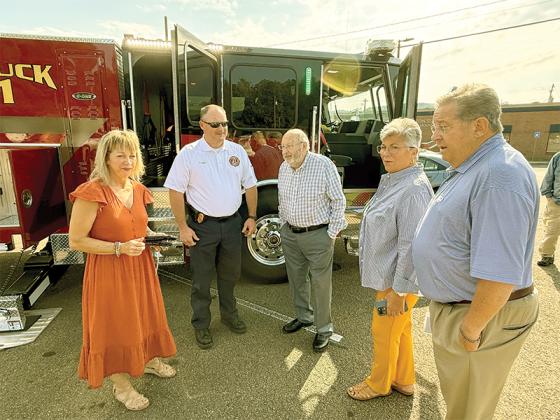 Gilmer County Public Safety Director and Fire chief Sam West (second from left) talks to Gilmer County Clerk Edwina Daman (far left), Gilmer County Chair Charlie Paris (center) and post commissioners Karleen Ferguson and John Marshall about the new truck. 