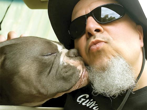 Volunteer Dave Krier poses with a dog who will be receiving food from the Gilmer Community Pet Food Pantry. (Contributed photo)