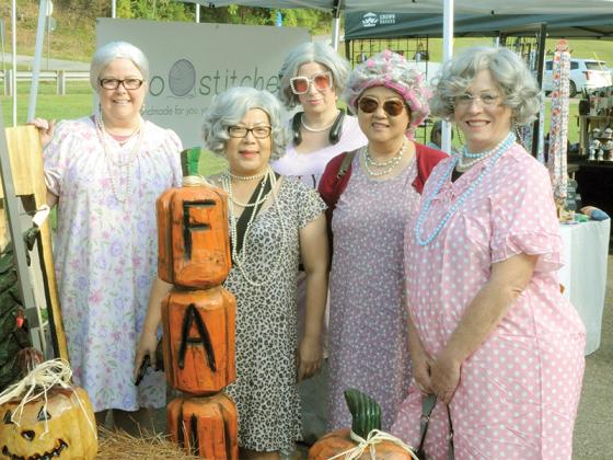 Shown in their gowns and wigs are (from left, front row) Phoumany Vignesult, Allison Yi and Stephanie Adam and (back row) Kathy Mahoney and Monica Bouve. 