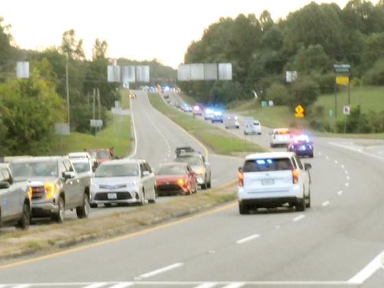 A procession of law enforcement vehicles escorts Worley on his trip home to Pickens County.