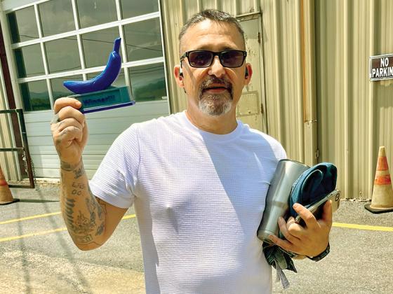 Gilmer County Food Pantry volunteer Anthony Watkins claims the Blue Banana Award June 4. (Photo by Allen Triebel/GCFP)