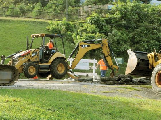 A Georgia Department of Transportation backhoe begins construction on the Highway 52 railroad crossing.