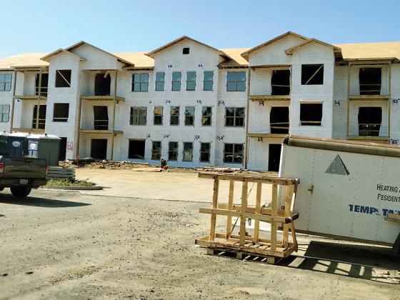 Pictured is one of two affordable housing complexes under construction at Overlook of Ellijay apartments on the hill above South Main Street and Industrial Boulevard. There will be a total of 50 1-, 2- and 3-bedroom units available; to apply, call 706-690-3235, and leave a message with your name and phone number. (Photo by Mark Millican)