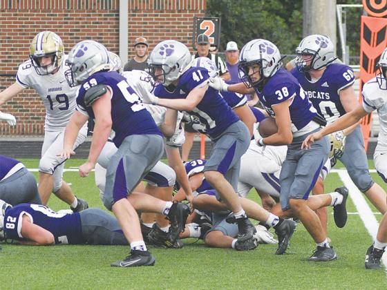 Gilmer freshman Silas West (38) gets behind the blocks of Parker Settel (59) and Hunter Newhart (41). West ran for 68 yards against White County while Settel recovered a fumble defensively.