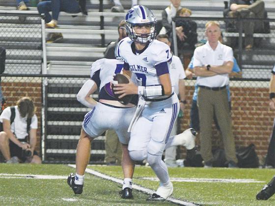 Gilmer High quarterback A.J. Callihan (7) rolls out and scans the field versus Calhoun last Friday. He threw for 128 yards and two touchdowns, which included a 22-yard touchdown to fellow sophomore McCoy Sutton (12, below).