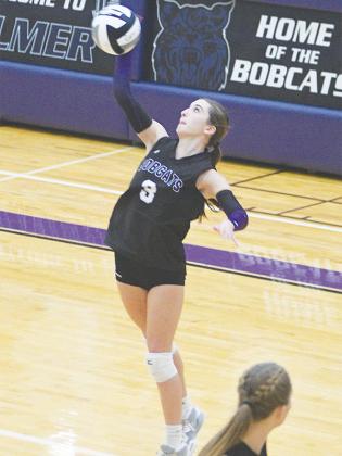 Gilmer High School freshman Kristina Bailey serves for the Lady Cats.