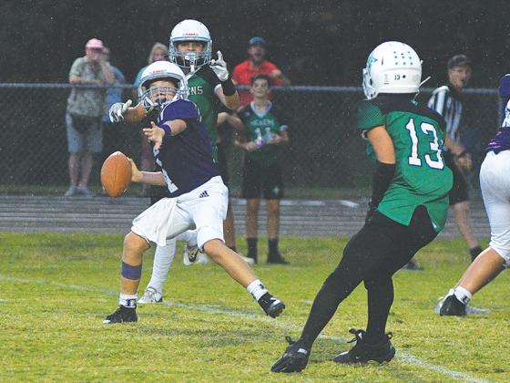 Clear Creek seventh-grade quarterback Bennett Brewer winds up for a pass in the Bobcats’ victory over Pickens.