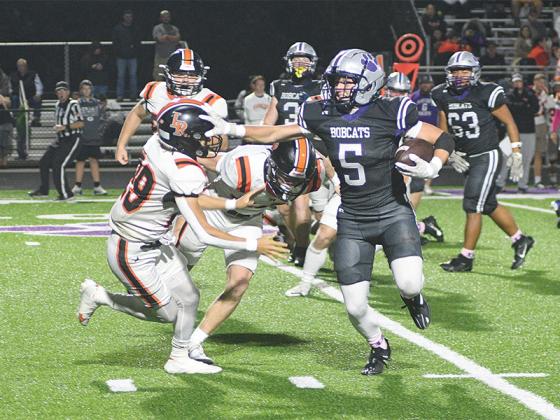 Gilmer senior halfback Hunter Britain stiff arms a Rambler defender last Friday, and finished the game with 64 rushing yards a touchdown on six carries.