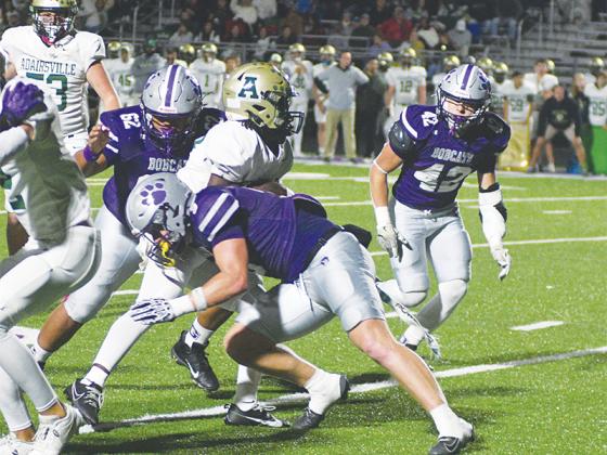 Gilmer’s Douglas Callihan (3) and Denny Ramirez (62) team up to make a tackle versus Adairsville as David Bright (42) closes in to assist.