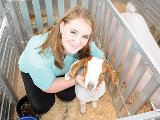 Gilmer County FFA junior Cassie Norman gives some affection to her goat, Birdie, as she prepares to show her at the Gilmer FFA’s livestock Saturday, Sept. 27.