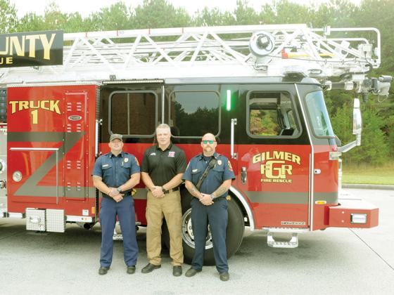 Gilmer County Fire Department chiefs stand beside their new ladder truck. From left are shown Battalion Chief Terence Evans, Deputy Chief of Administration Jason Bryant and  Battalion Chief C.J. Morris.