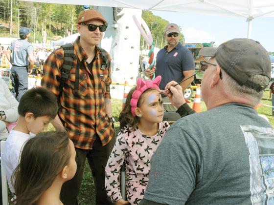 Hanah Combs gets her face painted at the Georgia Apple Festival, Saturday, Oct. 11. She and her family were among the thousands enjoying the event.