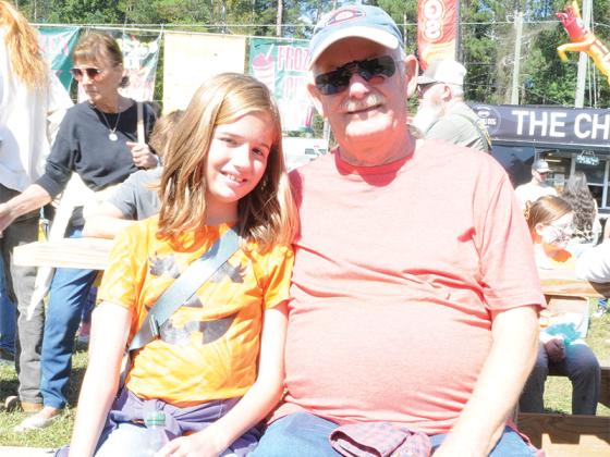 Amory White and her grandfather Brian Murphy take a moment together at the Georgia Apple Festival, Saturday, Oct. 11. For them, the event is a fond tradition.