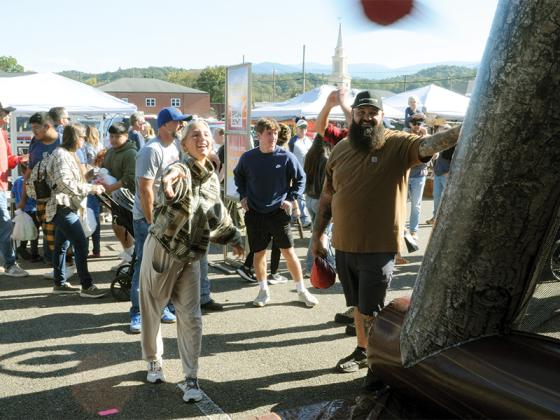 Marley Charles throws a Velcro inflatable hammer at the Georgia Apple festival Saturday, Oct. 11. It was just one of many games and activities on the offer.