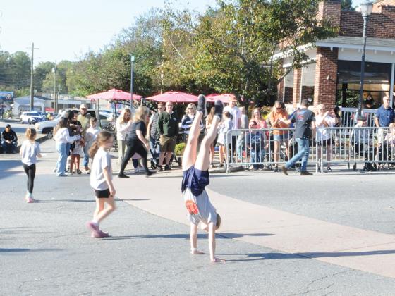 A girl with Elevation Gymnastics shows off her backflips at the Saturday, Oct. 11 Georgia Apple Festival Parade. She was among many students and children contributing to the parade.