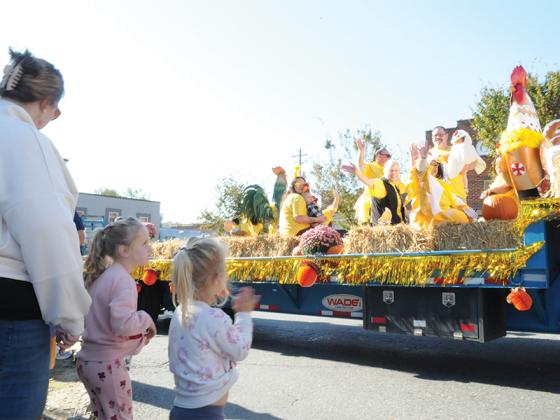 Two little girls greet a float at the Saturday, Oct. 11, Georgia Apple Festival Parade through downtown Ellijay. The parade and nearby market had fun attractions for people of all ages.
