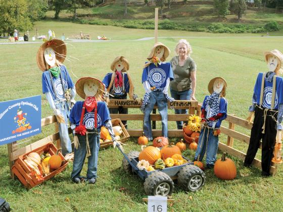 Rebecca Anderson shows off the Gilmer County Optimist Club’s scarecrows.