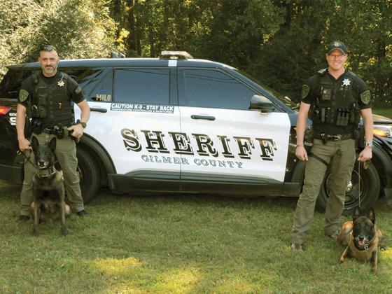 Gilmer County Sheriff’s Office officers Sergeant David Ridings, left, and Deputy Ron Scott, right, show K-9s Milo, left, and Novak, right. 