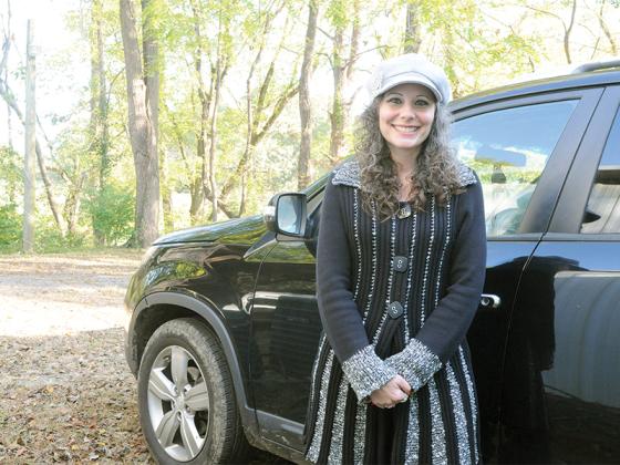 Gilmer Community Food Pantry Adopt-a-Family Coordinator Jessica Partin stands beside the car she delivers food in.