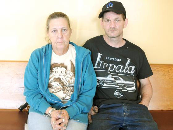 April Burrier, left, and Frank Whitcomb, right, visit the Gilmer Community Food Pantry after their trailer burnt down. 