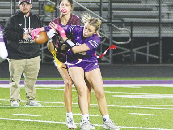 Gilmer’s Jocelyn McCollum (right) applies defensive pressure to break up a pass versus Dawson County last Thursday.