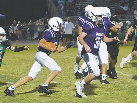 Clear Creek halfback Joshua Wooten runs behind fullback Jaxon Garland, and they were the seventh grade’s top ground gainers on the season.