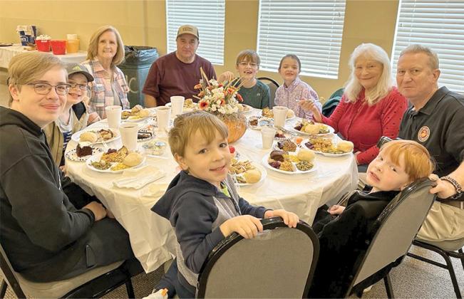 The Wright and Millican families enjoyed getting together during the Community Thanksgiving Dinner in 2023. The dinner has been cancelled for 2025, but will resume next year, organizers say. The free meal hosted at First Baptist Church Fellowship Hall is sponsored by Faith, Hope and Charity Recycle Store as a gift to the Gilmer County community. (Contributed photo)