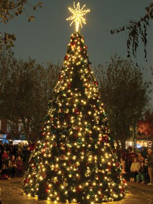 The downtown square had people everywhere hours before, during and after the traditional lighting of the Christmas tree on the square during Light Up Ellijay last year. (Photo by Mark Millican)