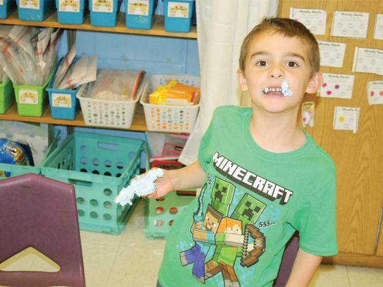 Ellijay Elementary School first-grader Jaden Morrow enjoys cotton candy at a Charlie Brown Thanksgiving Feast Friday, Nov. 21. Along with his classmates, he watched a video of a man reading a book version of the “A Charlie Brown Thanksgiving” TV special.