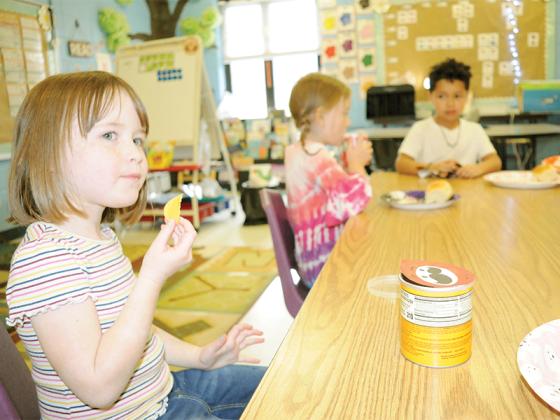 Ellijay Elementary School first-graders celebrate the holiday with a Charlie Brown Thanksgiving Feast Friday, Nov. 21. The kids relished a spread of bread, cotton candy, popcorn, pretzel sticks, gummies and more. Shown from left are, Aubrey Arnold, Eliza Pritchard and Max Orduna.