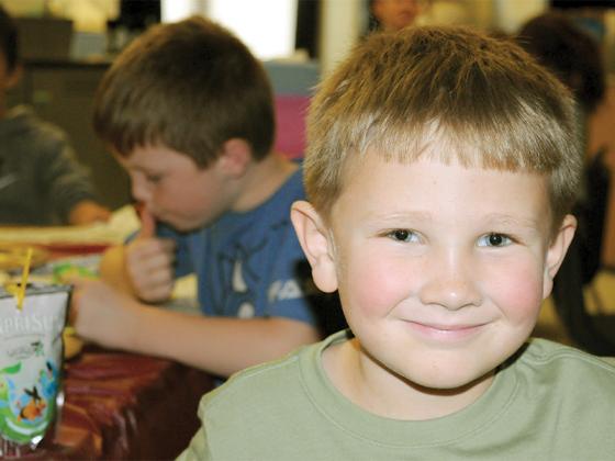 Ellijay Elementary School first-grader Jackson Hughes smiles as he experiences a Charlie Brown-style Thanksgiving Feast Friday, Nov. 21. For generations, watching “A Charlie Brown  Thanksgiving” has been a delight for adults and kids of all ages.