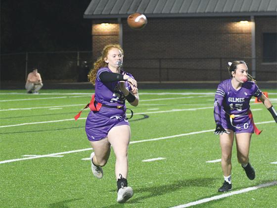 Gilmer’s Alyssa Hughes (15) blocks for Lady Cat quarterback Mattie Jones.