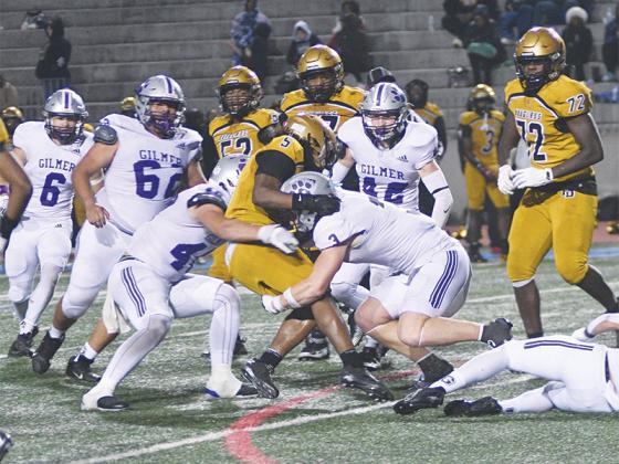 Gilmer’s Robert Pim (40) and Douglas Callihan (3)  tackle Douglass’ Janarius Gooden in the first round of the Class 3A state playoffs last Friday.