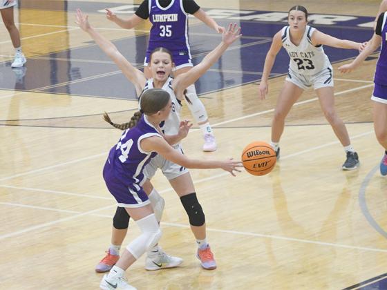 Kensie Farmer pressures the ball defensively.