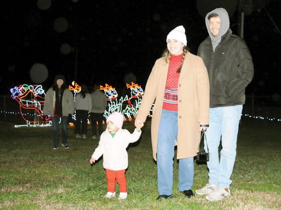 Together, a family admires the Holiday Lights of Ellijay 2025 display, put on by the Ellijay Lions Club. To see the lights, they drove from Atlanta. Shown from left are Alaina Kiss, Olivia Kiss and Ryan Kiss.