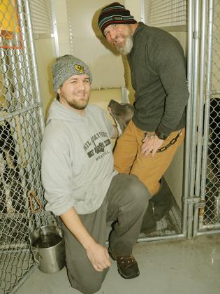Shown from left are Kennel Tech Benjamin Glodowski, Otis and Kennel Tech Will Rowlette.