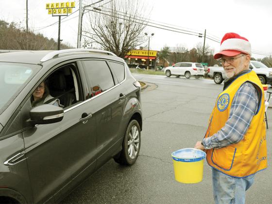 Ellijay Lions Club Lion Tamer Jim Harding collects donations from passing drivers for the club’s White Christmas fundraiser.