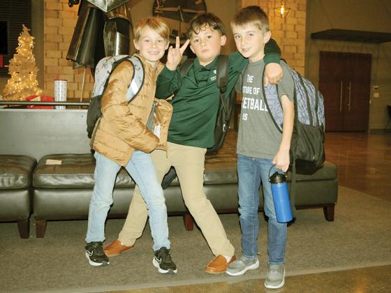North Georgia Christian Academy students stand together in front of the school’s massive knight statute. Shown from left are Daniel Coneby, Elias Barron and Hudson Coneby.