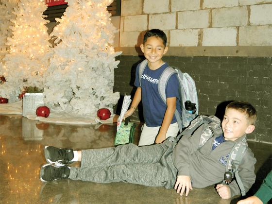 Two North Georgia Christian Academy students pose in front of a Christmas tree before going home for the weekend. Shown from left are Pedro Patino and Harrison Kovarovic.