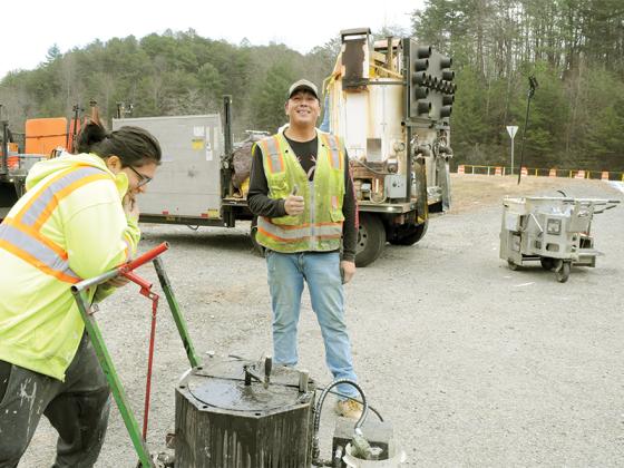 Joshua Joya, left, and Eddie Martinez, right, put the finishing touches on the GA 515 and Old Hwy. 5 Restricted Crossing U-Turn.